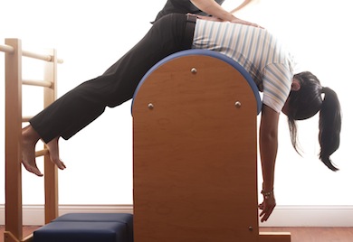 Back stretch on Pilates ladder barrel